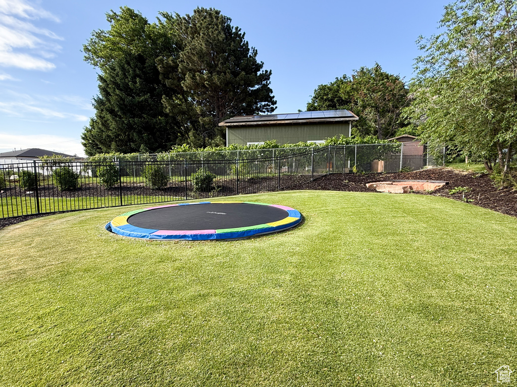 View of yard featuring a trampoline
