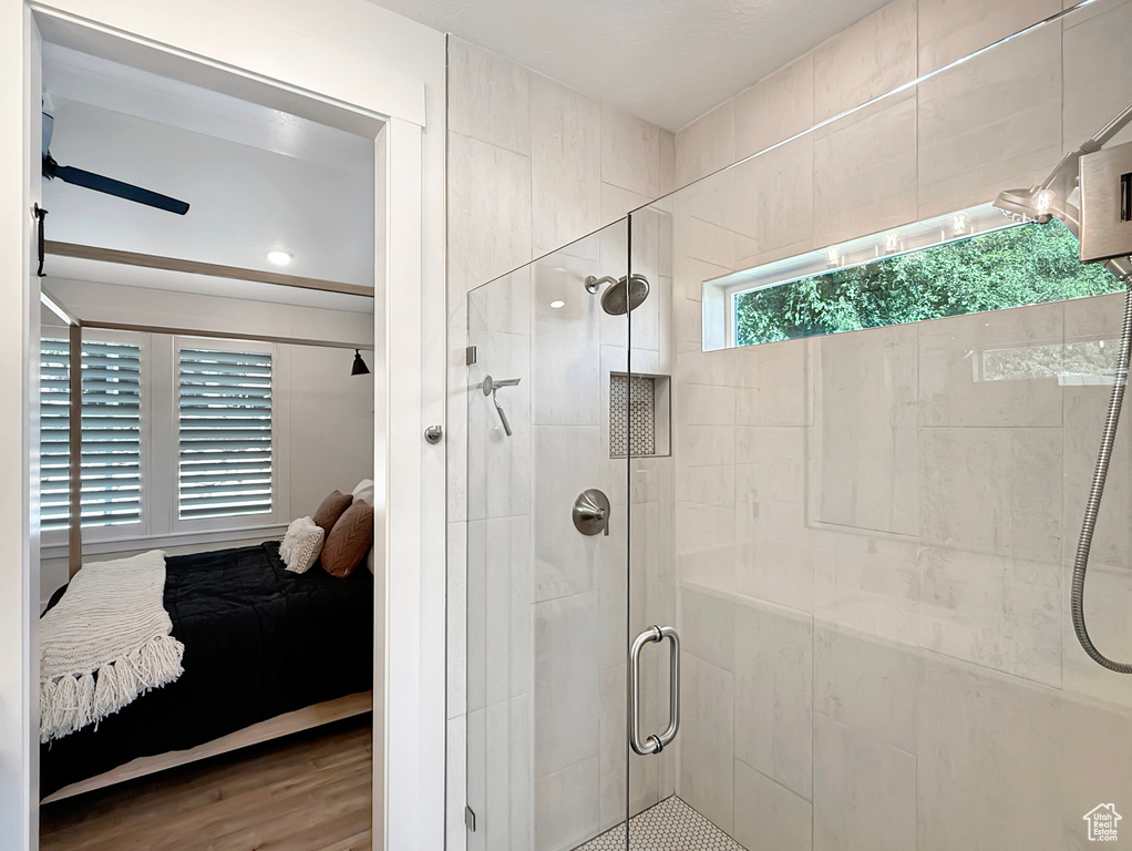 Bathroom featuring ensuite bathroom, a shower stall, and wood finished floors