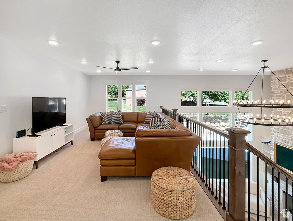 Living area with recessed lighting, carpet, a chandelier, a ceiling fan, and baseboards