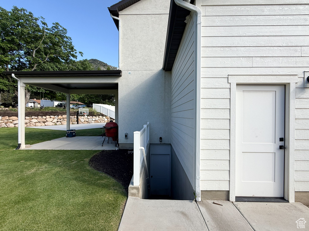 Doorway to property with a yard