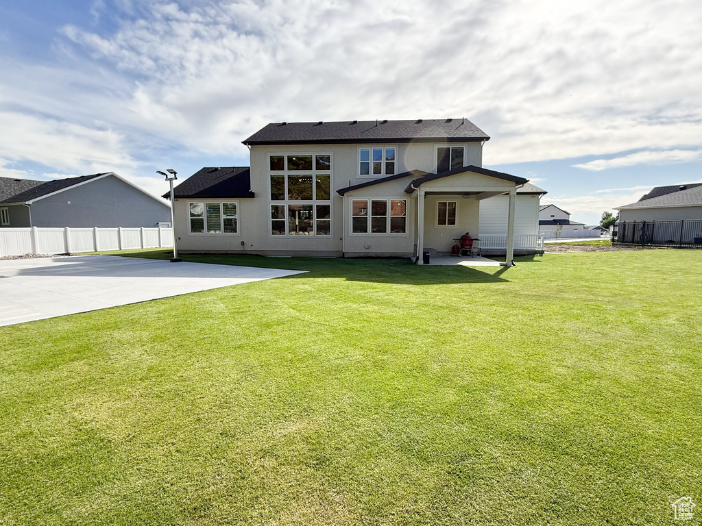 Back of house with a patio