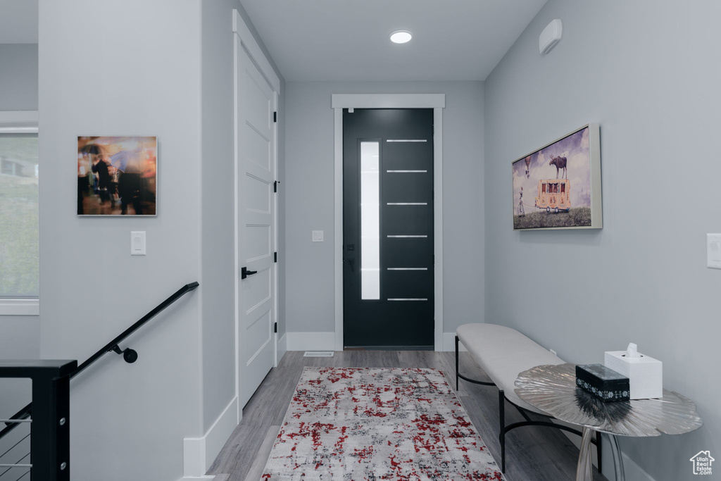 Foyer with wood finished floors, baseboards, and recessed lighting