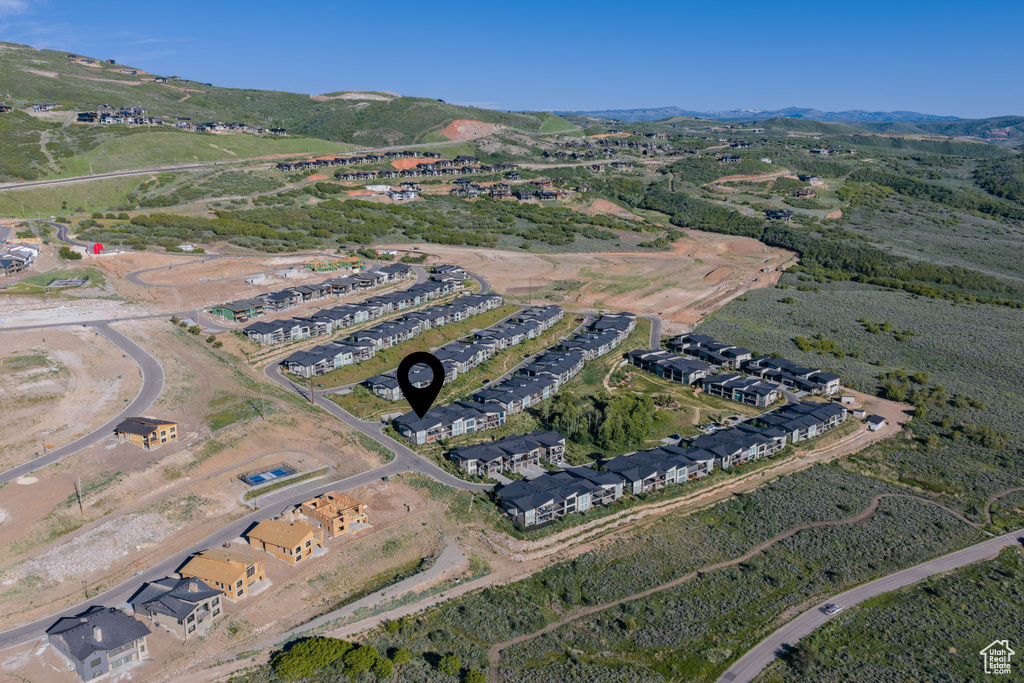 Aerial view of property\'s location featuring a mountain backdrop and nearby suburban area