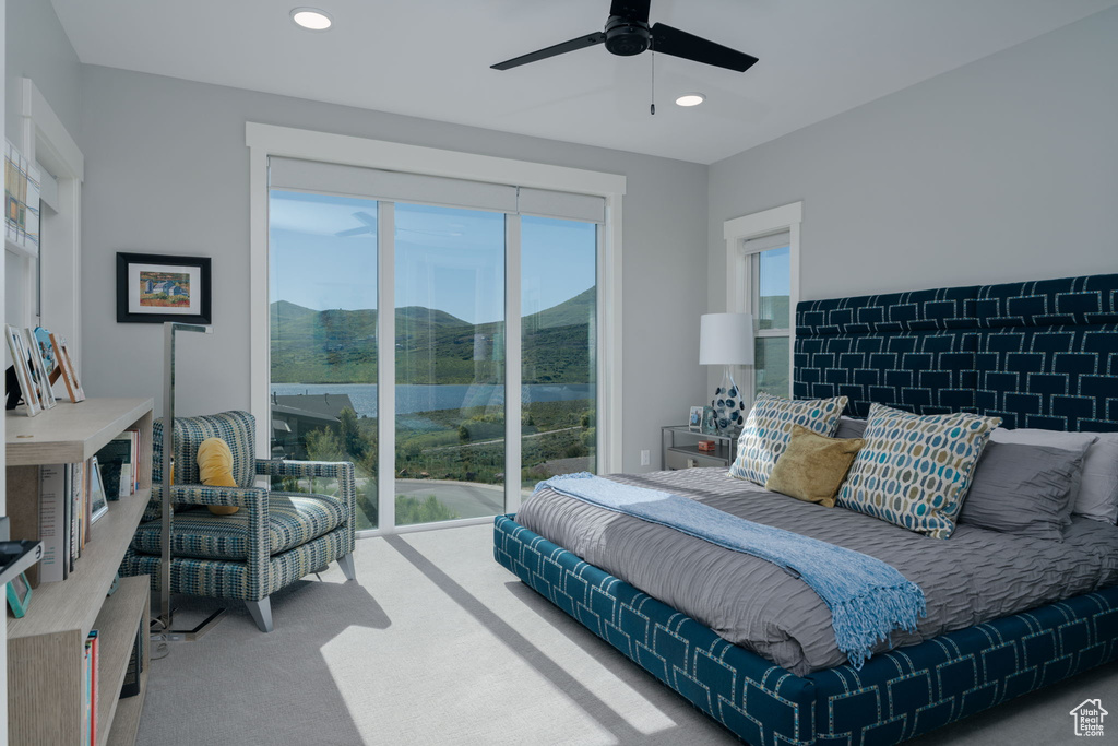 Bedroom with access to outside, carpet flooring, recessed lighting, a ceiling fan, and a water view