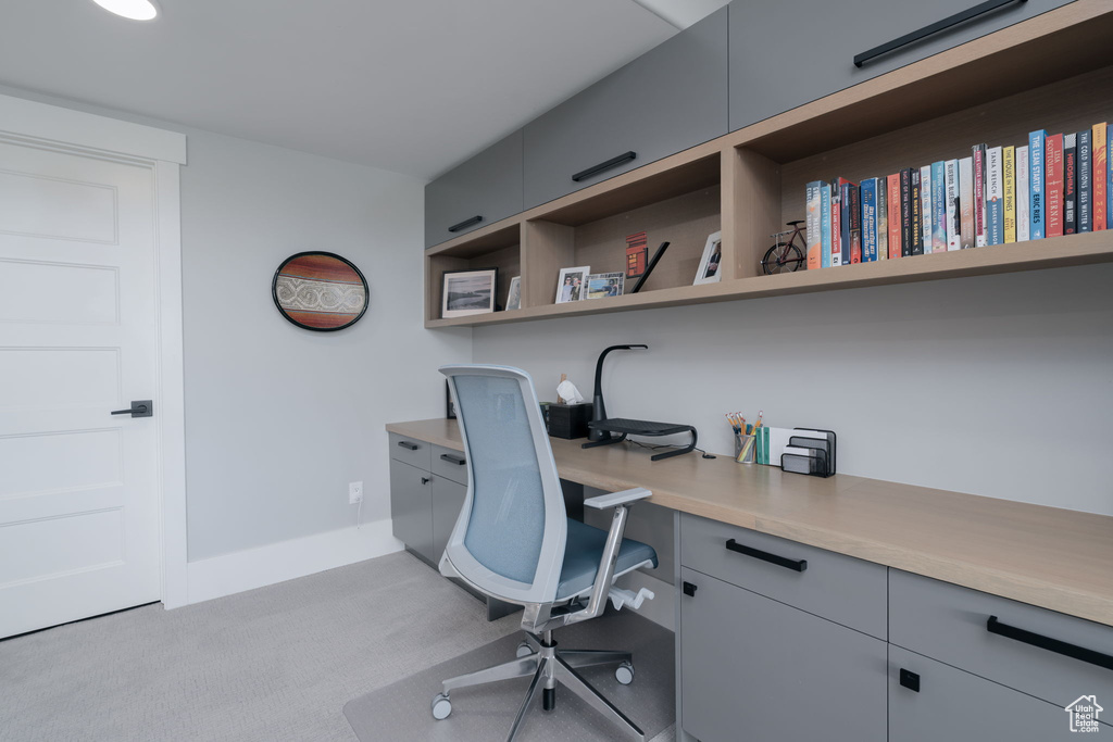 Office featuring light colored carpet and baseboards