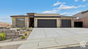 View of front of house with an attached garage and driveway