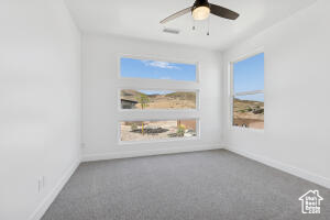 Spare room featuring baseboards, a ceiling fan, and carpet flooring