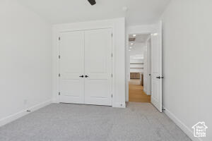 Unfurnished bedroom featuring carpet floors, baseboards, and a closet
