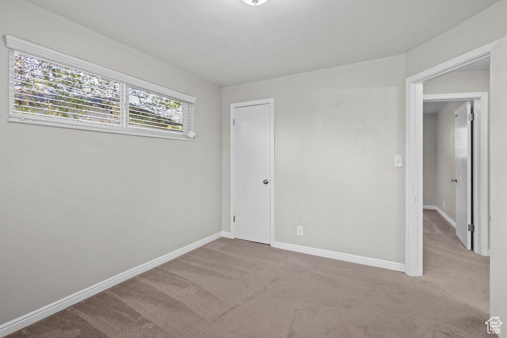 Unfurnished bedroom featuring carpet floors and baseboards