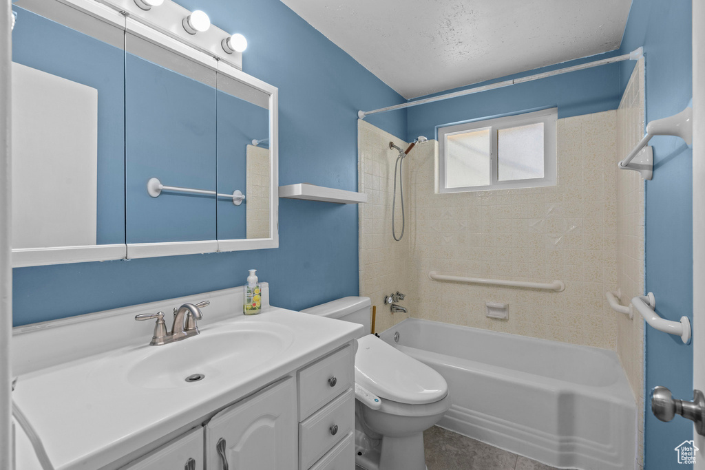Full bathroom featuring vanity, shower / bath combination, and toilet