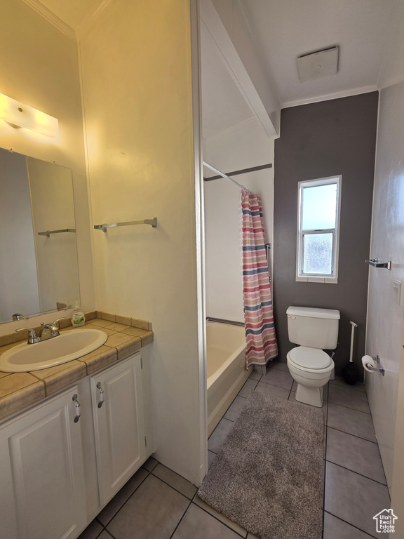 Full bathroom with vanity, tile patterned flooring, shower / bath combo, toilet, and ornamental molding