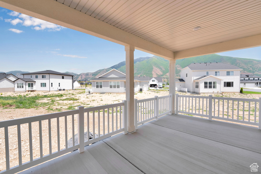 Porch with a residential view and a mountain view