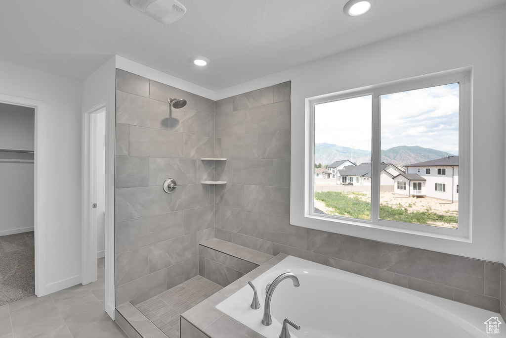 Bathroom with a bath, tiled shower, recessed lighting, and a mountain view
