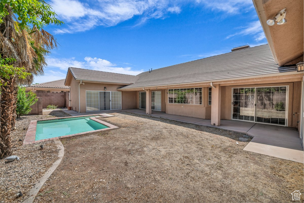 View of swimming pool featuring a patio and a fenced backyard