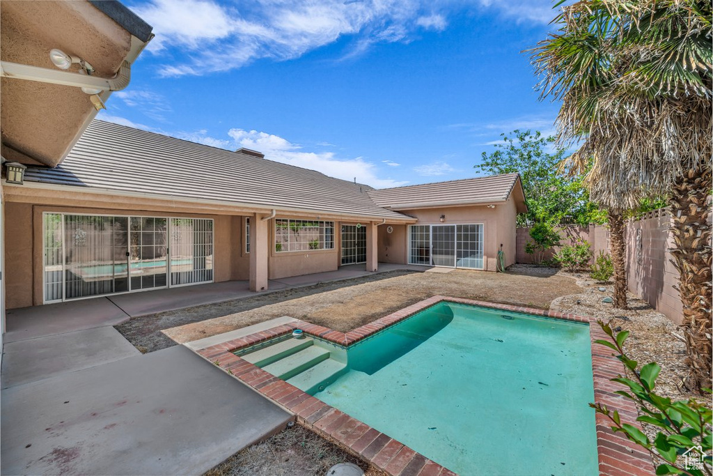 View of swimming pool featuring a patio and a fenced backyard