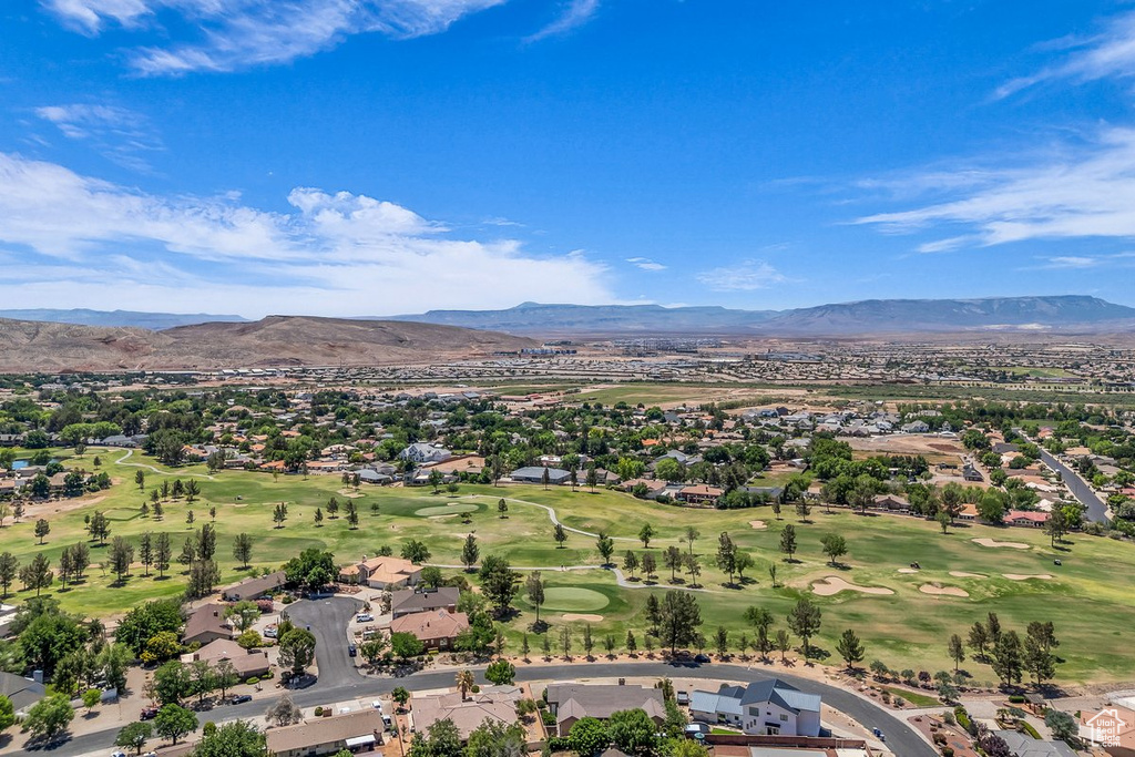 Aerial perspective of suburban area with mountains and a local golf course