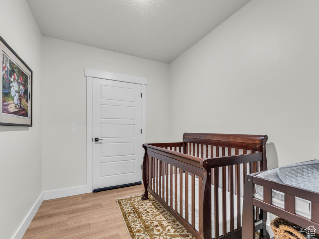 Bedroom with light wood-type flooring and baseboards