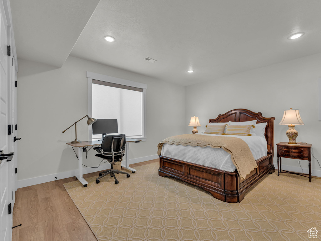 Bedroom with recessed lighting, a desk, light wood finished floors, and baseboards