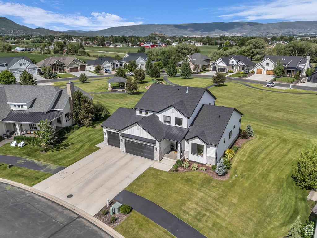 Aerial perspective of suburban area featuring a mountainous background