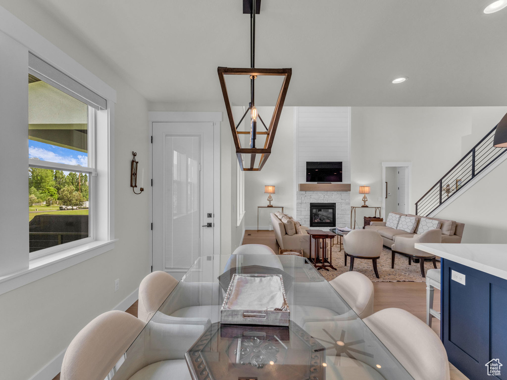 Living area featuring a fireplace, baseboards, wood finished floors, and recessed lighting