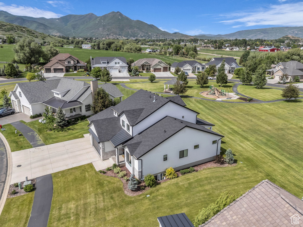 Aerial perspective of suburban area featuring a mountain backdrop