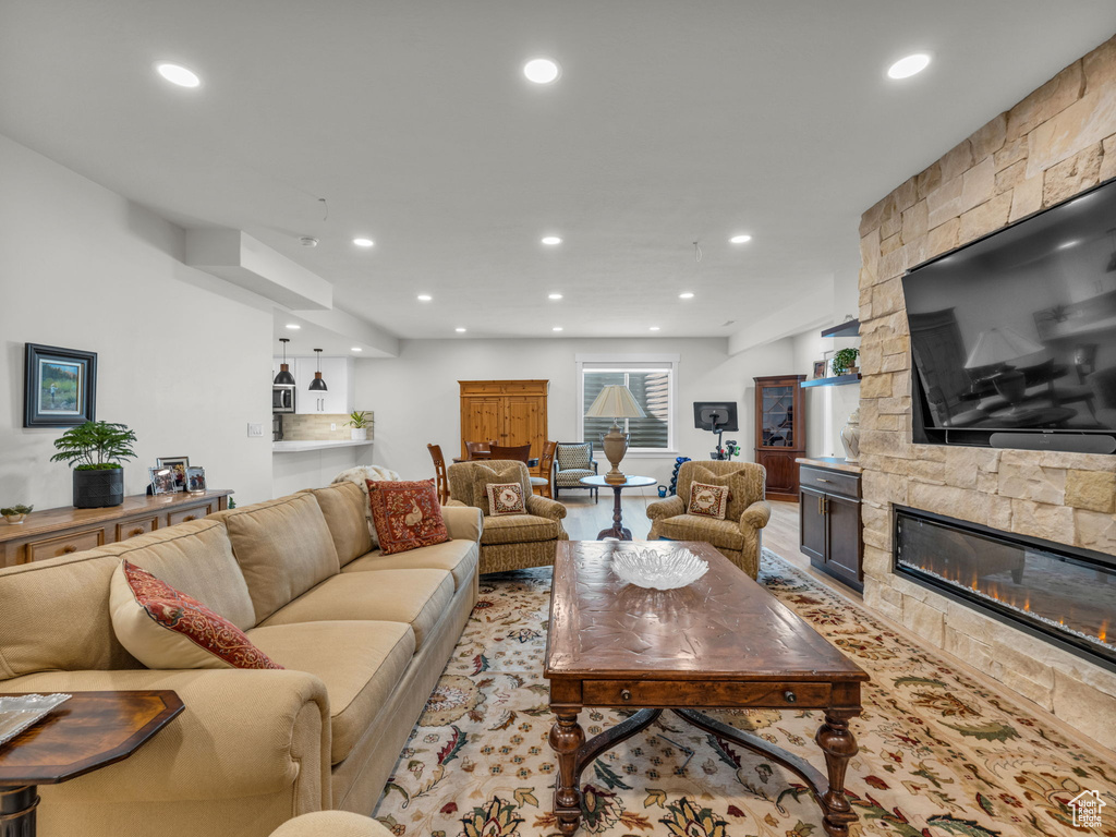 Living room with recessed lighting and a fireplace