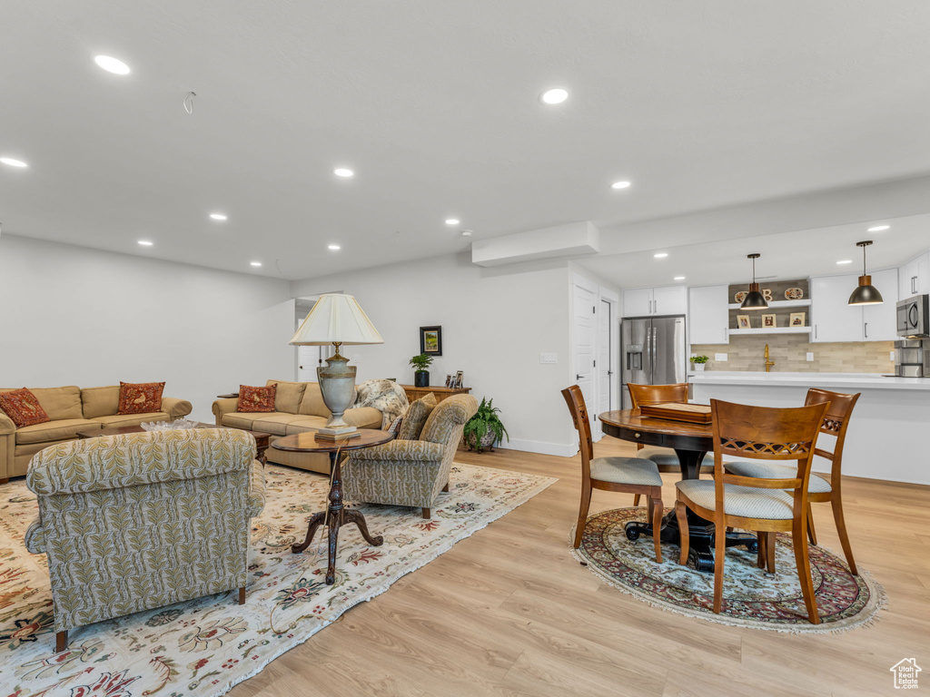 Living room featuring light wood finished floors, recessed lighting, and baseboards