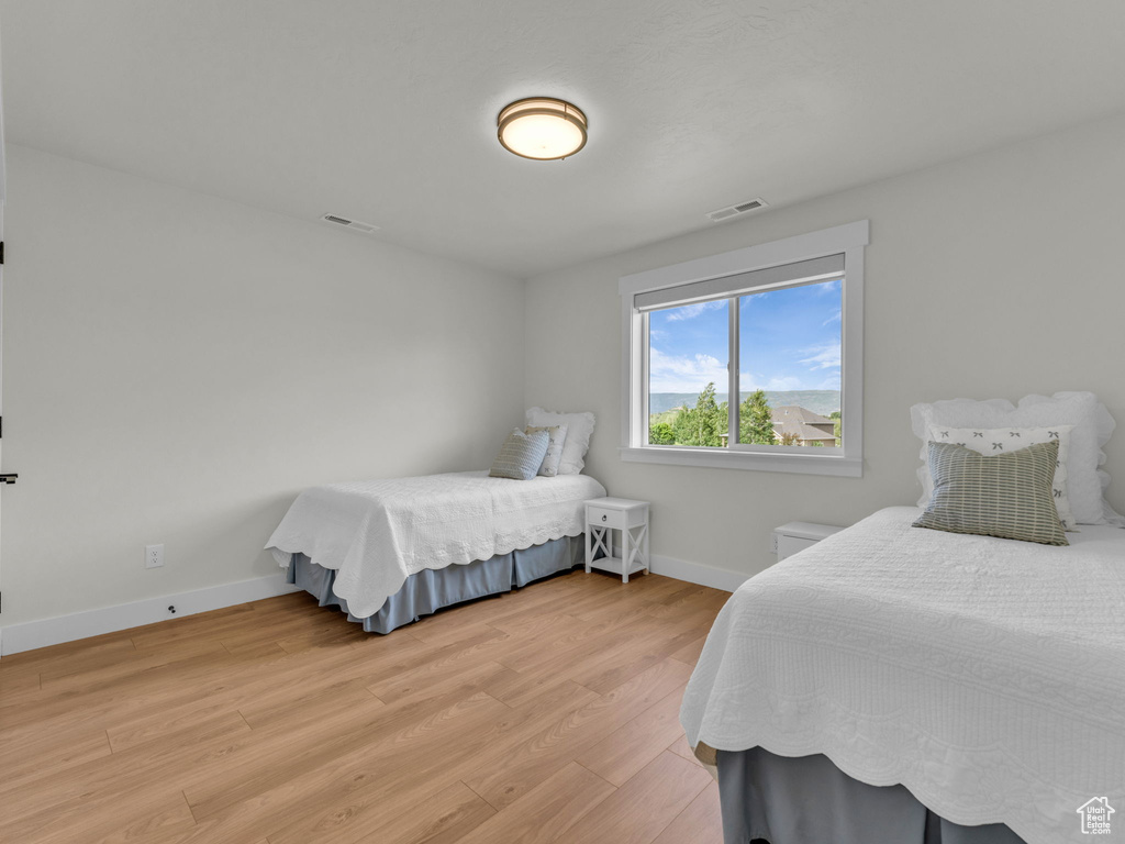 Bedroom featuring light wood-type flooring and baseboards