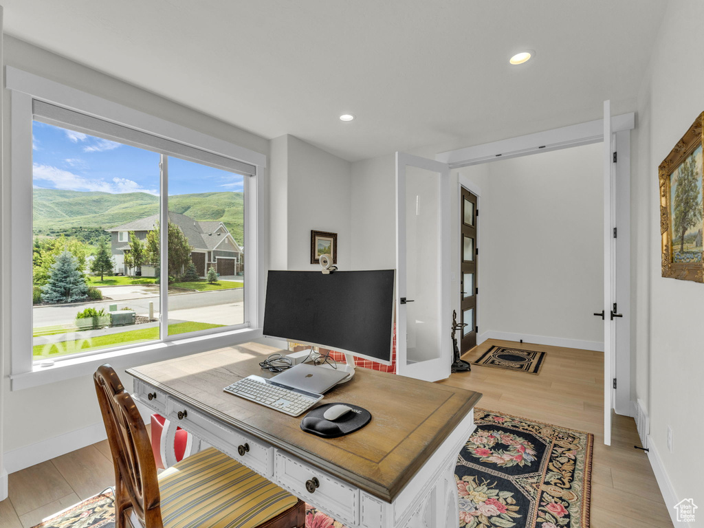 Office area with light wood-style flooring, recessed lighting, and baseboards