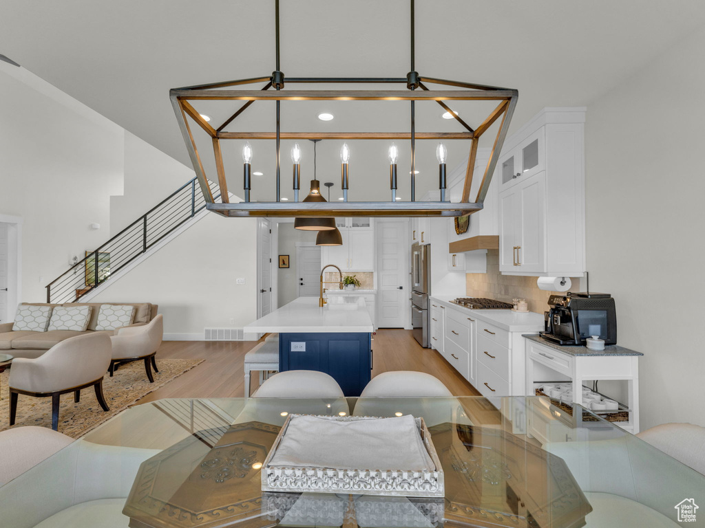 Living area featuring light wood-style floors and stairway