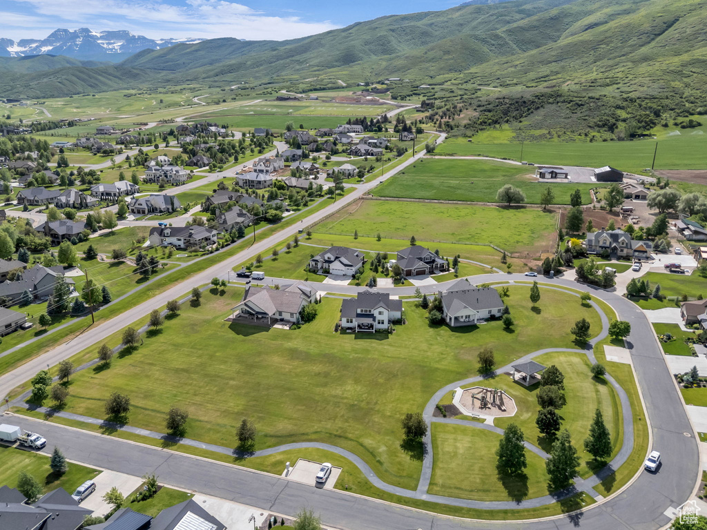 Aerial overview of property\'s location featuring nearby suburban area and a mountainous background