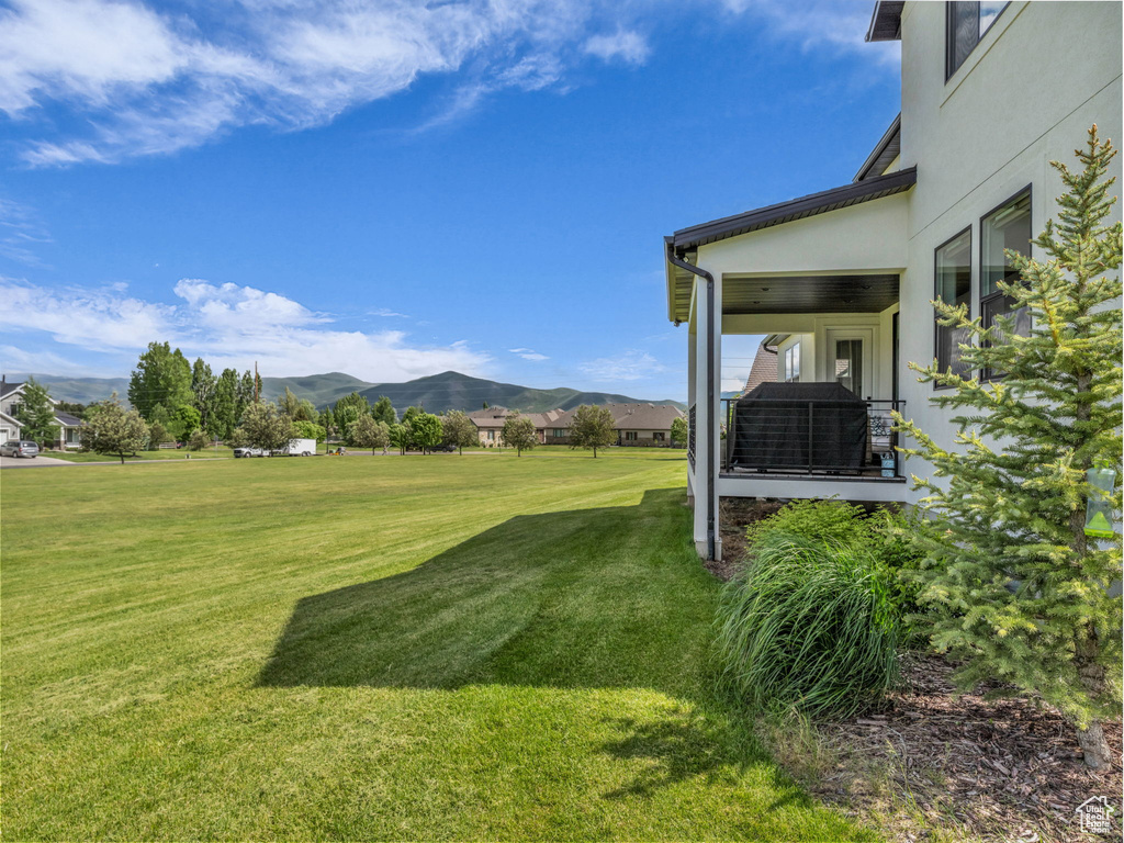 View of grassy yard with a mountain view