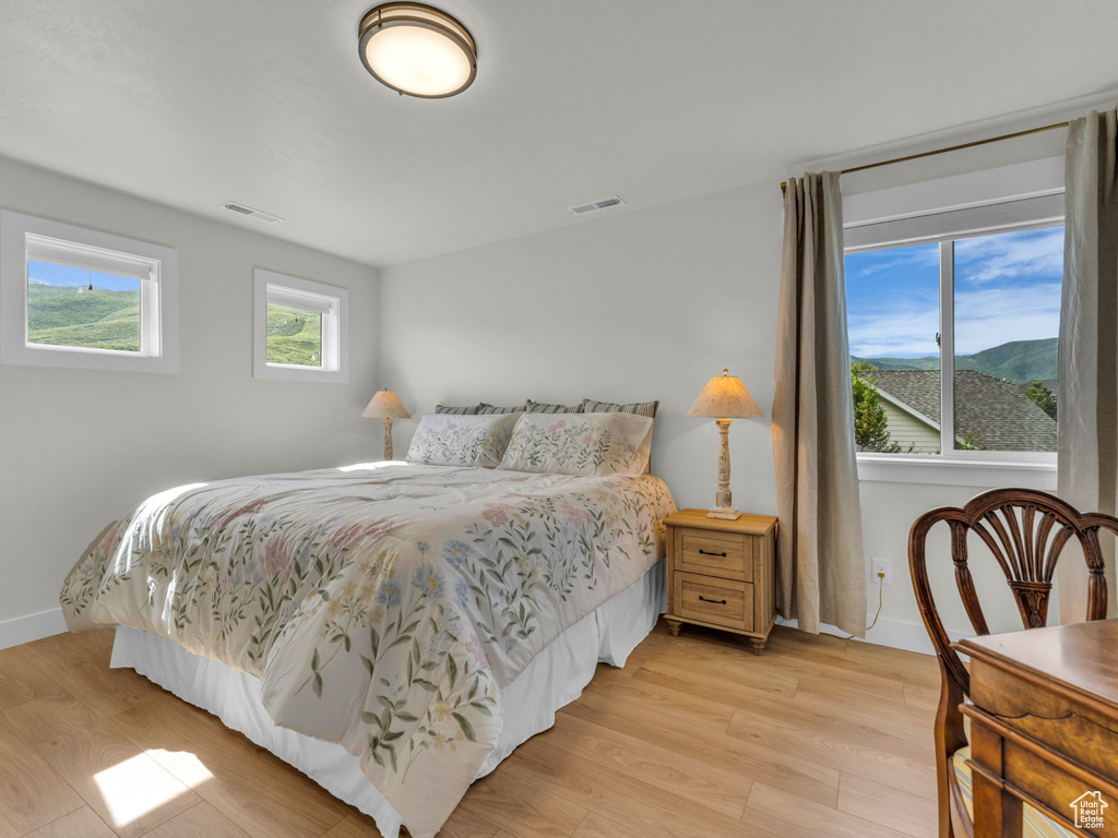 Bedroom featuring light wood-style flooring and baseboards