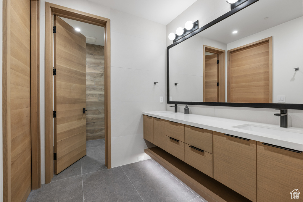 Bathroom featuring double vanity and tile patterned floors