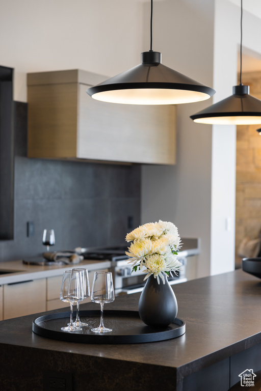Kitchen featuring tasteful backsplash and dark countertops
