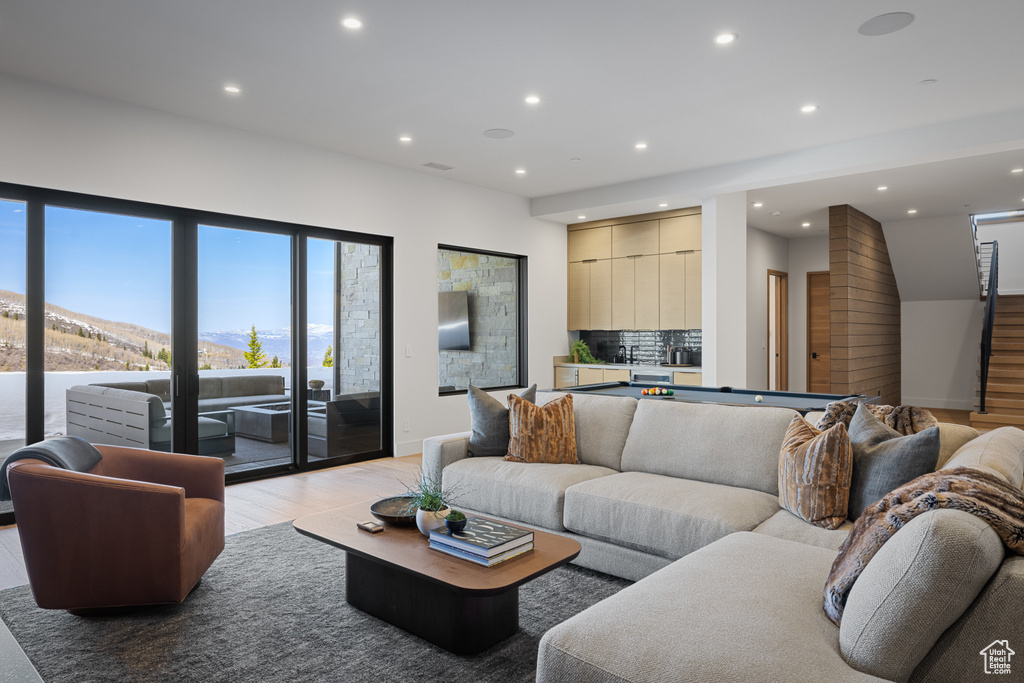 Living room with light wood-type flooring, recessed lighting, and billiards