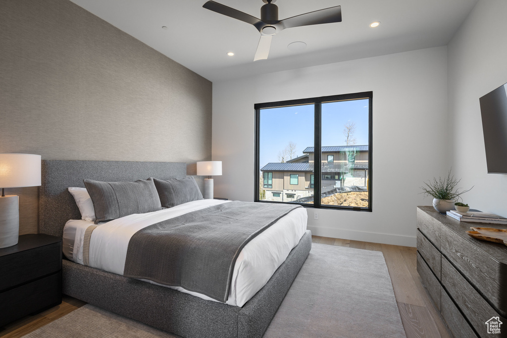 Bedroom featuring light wood finished floors, recessed lighting, a ceiling fan, and baseboards
