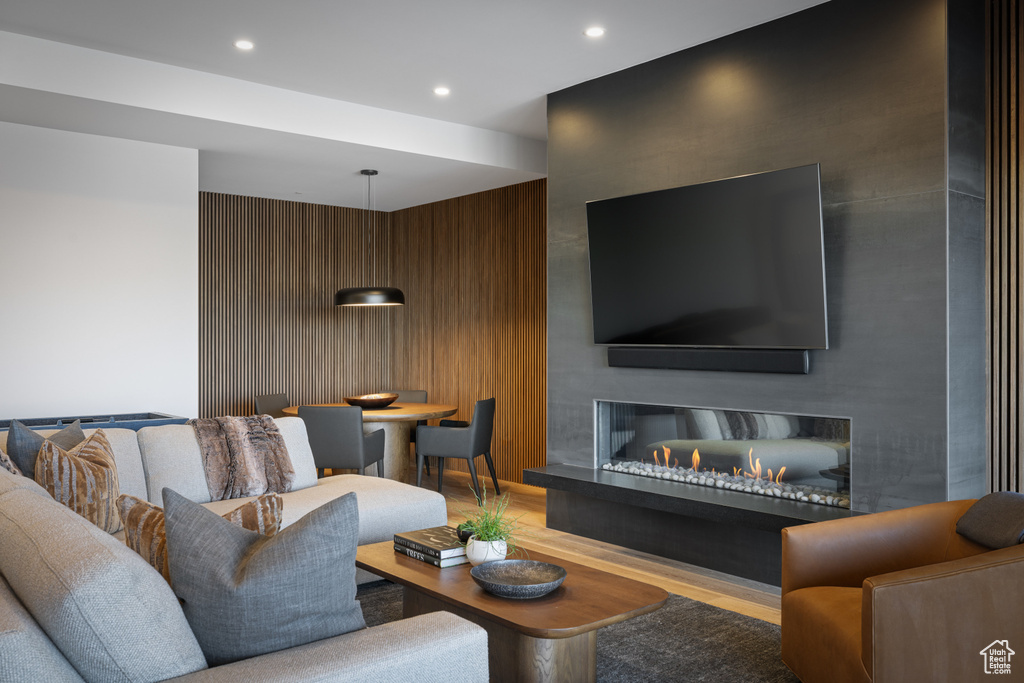 Living room with light wood-style flooring and recessed lighting