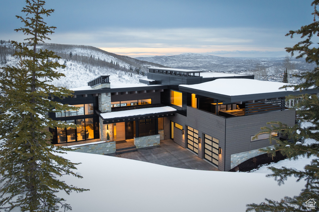 Contemporary house with a mountain view, a garage, and stone siding