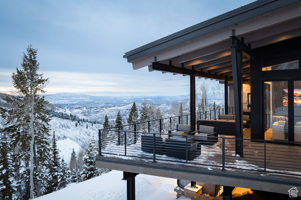 Snow covered deck with a mountain view