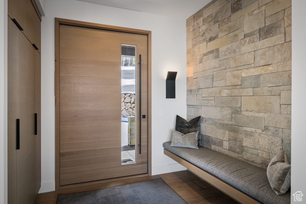 Foyer featuring a sauna / steam room, baseboards, and wood finished floors
