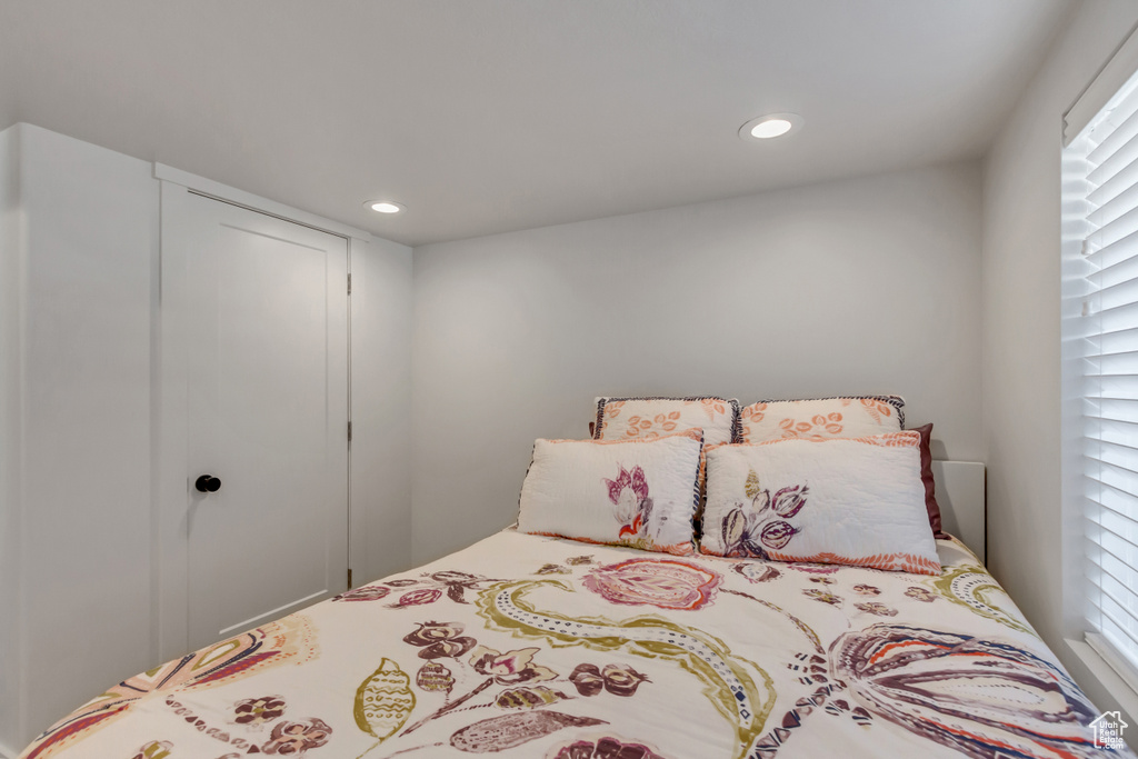 Bedroom featuring multiple windows, recessed lighting, and a closet