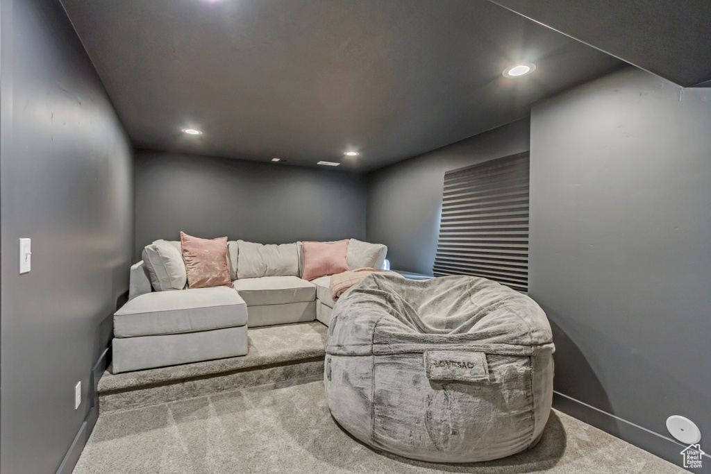 Carpeted living room with recessed lighting and baseboards