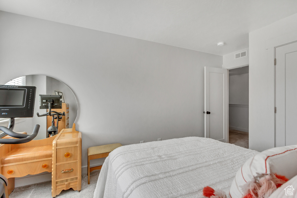 Bedroom with light colored carpet