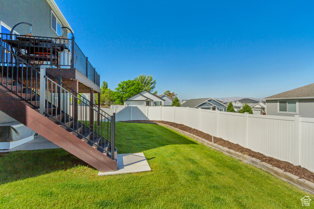 View of yard with stairway and a wooden deck