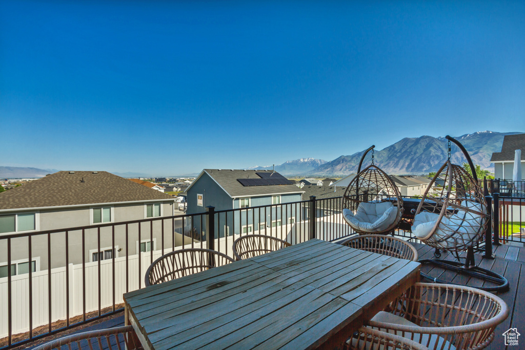 Deck with outdoor dining area and a mountain view