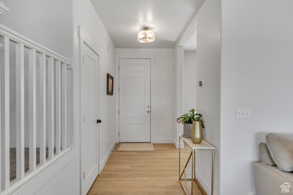 Foyer with light wood-style flooring and baseboards