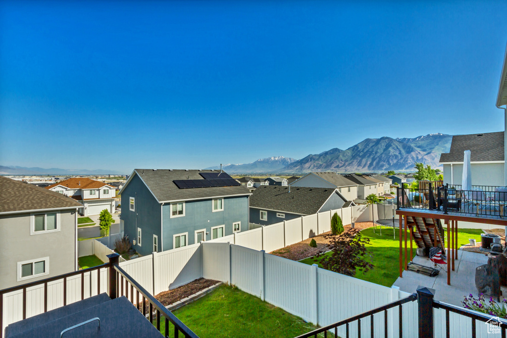 Balcony with a residential view, a patio area, a deck with mountain view, and stairway