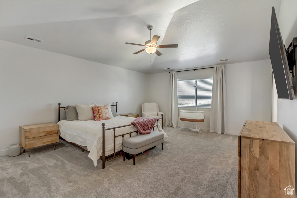 Carpeted bedroom featuring a ceiling fan
