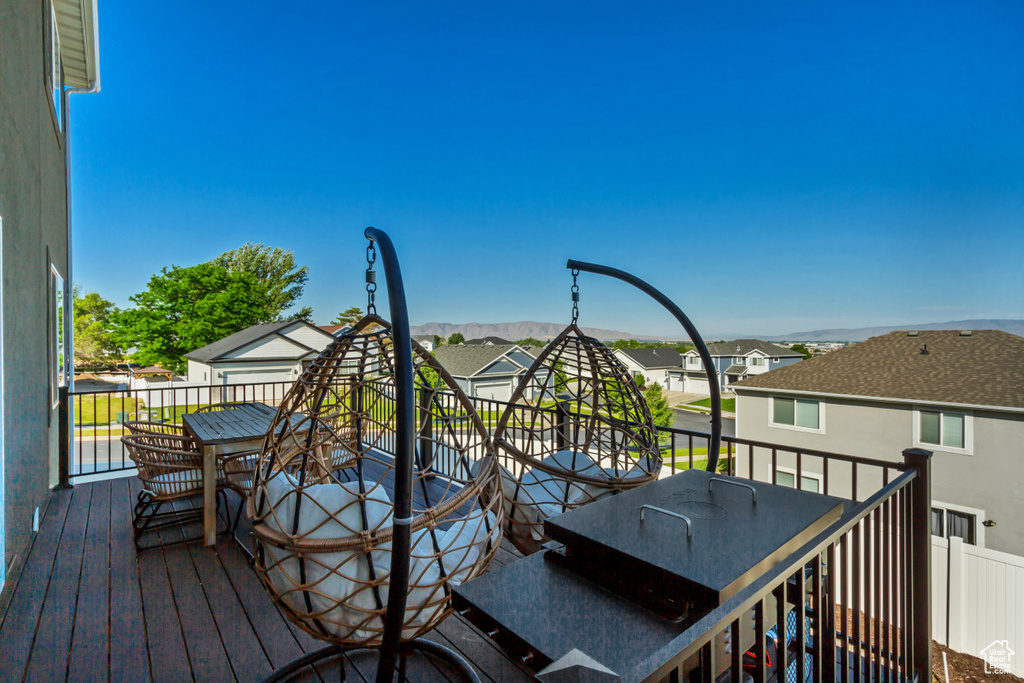 Deck featuring outdoor dining space, a residential view, and a mountain view
